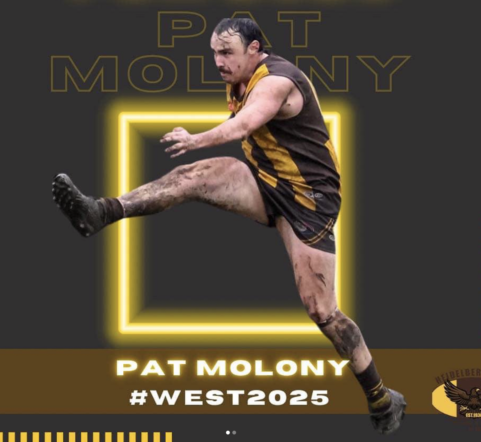 Pat Molony launching a kick in full flight — Heidelberg West guernsey, mud-stained and airborne